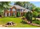 Charming two-story brick home with well-manicured front yard and lush landscaping at 1490 Rivershyre Pkwy, Lawrenceville, GA 30043
