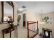 Upper hallway showcases a decorative mirror and a staircase leading to the entry at 1490 Rivershyre Pkwy, Lawrenceville, GA 30043