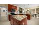 Open kitchen featuring an island, granite countertops, and views to the backyard at 1490 Rivershyre Pkwy, Lawrenceville, GA 30043