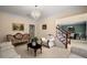 Bright living room with a chandelier, neutral walls, and views into the dining room at 1490 Rivershyre Pkwy, Lawrenceville, GA 30043