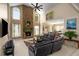 Inviting living room with stone fireplace, vaulted ceilings, and modern black leather furniture at 1490 Rivershyre Pkwy, Lawrenceville, GA 30043