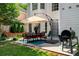 Outdoor patio features a dining set with an umbrella and a grill at 1490 Rivershyre Pkwy, Lawrenceville, GA 30043