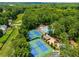 Aerial view of tennis courts near pool and clubhouse amidst a lush landscape at 1490 Rivershyre Pkwy, Lawrenceville, GA 30043