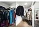 Spacious walk-in closet with plentiful storage, shelves, and hanging rods at 1490 Rivershyre Pkwy, Lawrenceville, GA 30043