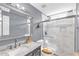 Updated bathroom showcases a marble countertop, modern fixtures, and a glass-enclosed shower for a spa-like experience at 1945 Kevin Se Dr, Conyers, GA 30013