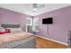 Cozy bedroom features pink walls, hard wood floors, and a ceiling fan for year-round comfort at 1945 Kevin Se Dr, Conyers, GA 30013