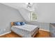 Charming bedroom with wood floors, window with blinds, and neutral wall color for a relaxing ambiance at 1945 Kevin Se Dr, Conyers, GA 30013