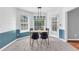 Bright dining area with natural light, a modern table, and stylish blue and white wainscoting at 1945 Kevin Se Dr, Conyers, GA 30013
