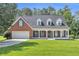 Charming brick home featuring a well-manicured lawn and inviting front porch with columns at 1945 Kevin Se Dr, Conyers, GA 30013