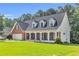 Beautiful exterior showcasing a brick facade, lush lawn, and a welcoming porch with decorative columns at 1945 Kevin Se Dr, Conyers, GA 30013