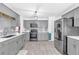 Modern kitchen featuring gray cabinets, stainless steel appliances, and light wood-look flooring at 1945 Kevin Se Dr, Conyers, GA 30013