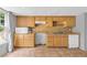 Kitchen features light wood cabinets, a sink, and appliances at 1945 Kevin Se Dr, Conyers, GA 30013