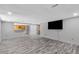 Spacious living room with gray wood flooring, a pass-through, and a television at 1945 Kevin Se Dr, Conyers, GA 30013