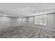 Open living room with lots of natural light and gray wood flooring at 1945 Kevin Se Dr, Conyers, GA 30013