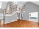 Open-concept living room featuring hardwood floors, a staircase, and ample natural light from large windows at 1945 Kevin Se Dr, Conyers, GA 30013