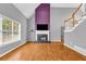 Spacious living room with a fireplace, hardwood floors, and staircase, offering a cozy atmosphere at 1945 Kevin Se Dr, Conyers, GA 30013