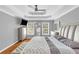 Bright main bedroom with tray ceiling, hardwood floors, and a cozy sitting bench at 1945 Kevin Se Dr, Conyers, GA 30013
