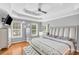 Spacious main bedroom with tray ceiling, wood floors, and natural light from large windows at 1945 Kevin Se Dr, Conyers, GA 30013