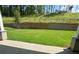 Spacious backyard with stone retaining wall and wrought iron fence behind a home at 2455 Bleckley Pl, Cumming, GA 30041