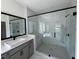 Modern bathroom with marble tile, glass shower, and a sleek vanity with black hardware at 2455 Bleckley Pl, Cumming, GA 30041
