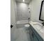 Bright bathroom featuring marble tile, a bathtub, a shower and modern vanity with black hardware at 2455 Bleckley Pl, Cumming, GA 30041
