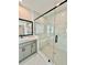 Elegant bathroom with modern walk-in shower, marble-style walls, and vanity at 2455 Bleckley Pl, Cumming, GA 30041