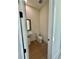 Modern half bathroom featuring pedestal sink, toilet, and wood-style flooring at 2455 Bleckley Pl, Cumming, GA 30041