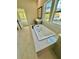 Bright bathroom featuring a luxurious soaking tub and marble tile at 2455 Bleckley Pl, Cumming, GA 30041