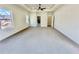 Spacious bedroom with plush carpet, a ceiling fan, and a walk-in closet at 2455 Bleckley Pl, Cumming, GA 30041