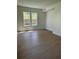 Bright and airy bedroom featuring hardwood floors and large windows overlooking the backyard at 2455 Bleckley Pl, Cumming, GA 30041