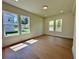 Sun-filled bedroom featuring hardwood floors, recessed lights, and multiple windows at 2455 Bleckley Pl, Cumming, GA 30041