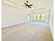 Expansive bedroom with plush carpet, large windows, and a ceiling fan at 2455 Bleckley Pl, Cumming, GA 30041