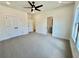 Bedroom featuring plush carpet, a ceiling fan, and access to an ensuite bathroom at 2455 Bleckley Pl, Cumming, GA 30041