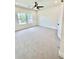 Bright bedroom with plush carpet, ceiling fan, and natural light from two windows at 2455 Bleckley Pl, Cumming, GA 30041