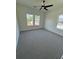 Bedroom with hardwood floors, two large windows offering natural light, and modern ceiling fan at 2455 Bleckley Pl, Cumming, GA 30041