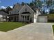 Spacious two-story home with a brick facade, attached two-car garage, and wide concrete driveway at 2455 Bleckley Pl, Cumming, GA 30041