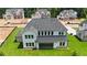 New construction home with a dark roof, a flat backyard, and a two-car garage at 2455 Bleckley Pl, Cumming, GA 30041