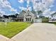 Charming two-story home with a light brick exterior, lush lawn, and a large drive at 2455 Bleckley Pl, Cumming, GA 30041