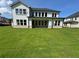 Large home exterior with multiple windows, covered porch, and expansive green lawn at 2455 Bleckley Pl, Cumming, GA 30041