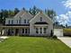 Elegant two-story home with a brick facade, lush green lawn, and attached two-car garage at 2455 Bleckley Pl, Cumming, GA 30041
