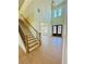 Grand foyer with hardwood floors, staircase, and view of front doors and living area at 2455 Bleckley Pl, Cumming, GA 30041