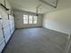 Spacious unfinished two car garage with windows and concrete floor at 2455 Bleckley Pl, Cumming, GA 30041
