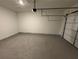 Spacious unfinished garage with white walls and concrete floor ready for your design at 2455 Bleckley Pl, Cumming, GA 30041