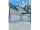 Spacious three-car garage with white doors and light brick exterior at 2455 Bleckley Pl, Cumming, GA 30041