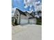 Spacious three-car garage with white doors and light brick exterior at 2455 Bleckley Pl, Cumming, GA 30041