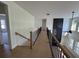 Hallway featuring wood floors and black iron railings overlooking an open concept living space at 2455 Bleckley Pl, Cumming, GA 30041