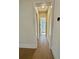 Hallway with wooden floor leading to door with natural light at 2455 Bleckley Pl, Cumming, GA 30041