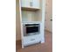 Built-in stainless steel microwave with white cabinets and a pull out drawer underneath at 2455 Bleckley Pl, Cumming, GA 30041