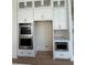 Kitchen features a double wall oven, white cabinets, and stainless steel appliances at 2455 Bleckley Pl, Cumming, GA 30041