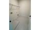Well-lit laundry room featuring patterned tile flooring and a convenient wire shelf for storage at 2455 Bleckley Pl, Cumming, GA 30041